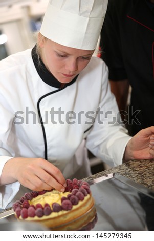 Portrait of pastry cook student making cake