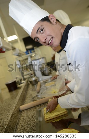 Pastry cook student making cake