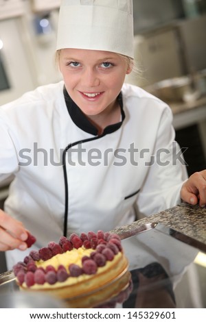 Portrait of pastry cook student making cake