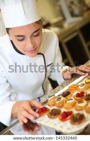 Cheerful Pastry Cook Holding Tray Of Pastries