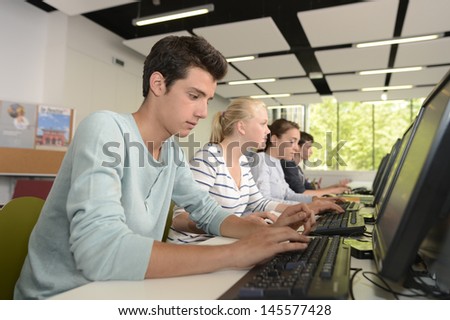 School boy in computing class using computer