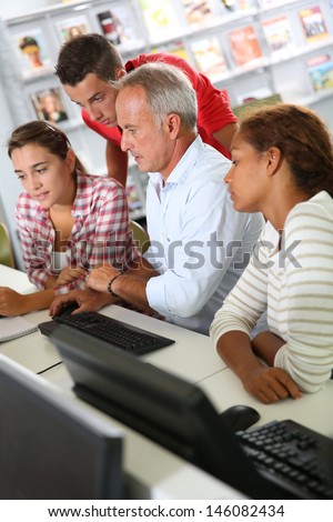 Teenagers with teacher in computers\' class