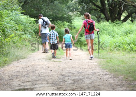 Back view of family on a trekking day in countryside