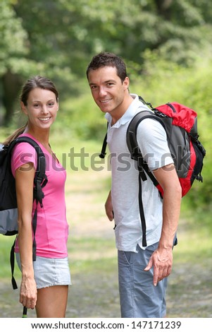Couple in countryside walking on a trekking path