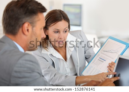 Young Woman Presenting Business Plan To Financial Investor