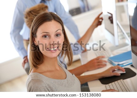 Woman in business training sitting in front of desktop