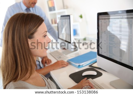 Woman in business training sitting in front of desktop
