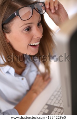 Woman looking at computer screen in office