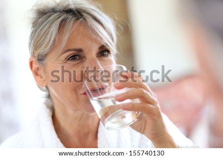 Senior Woman Drinking Water In The Morning