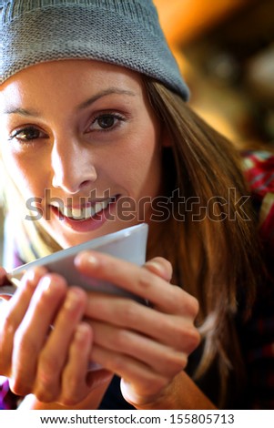 Trendy girl at home having hot drink
