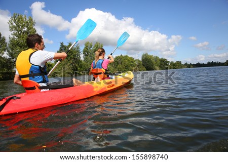 Couple Riding Canoe In River