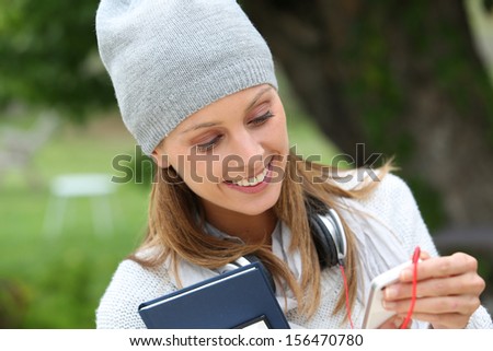 Student girl in College campus listening to music