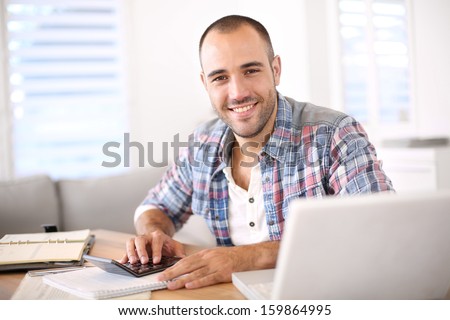 Man working on laptop computer from home