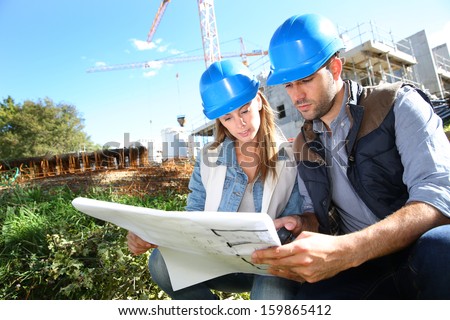 Construction engineers working together on site