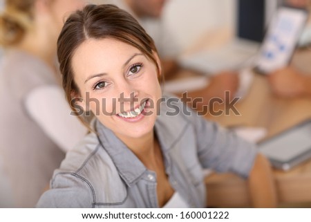 Portrait of business girl sitting at table for meeting