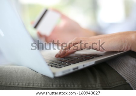 Hand holding credit card to buy online
