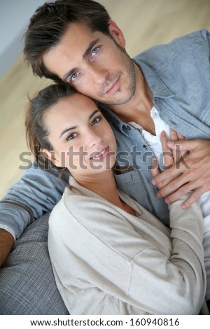 Upper view of couple at home relaxing in sofa
