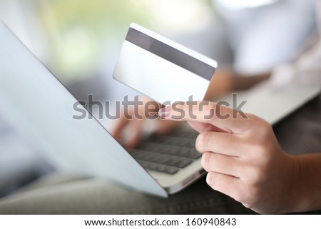 Hand holding credit card to buy online
