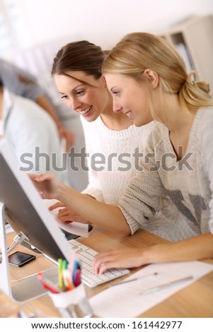 College girls working in front of desktop