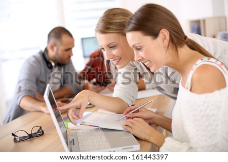 School girls in class studying on laptop computer