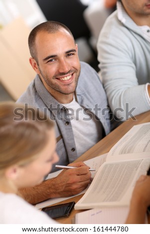 Smiling guy in business training attending meeting