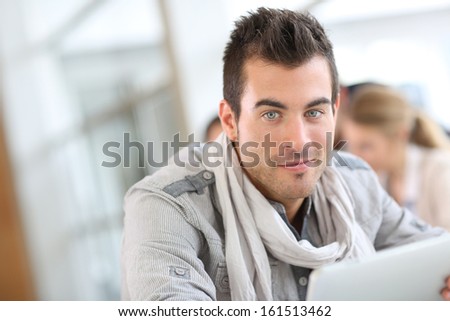 Portrait of smiling student guy in class