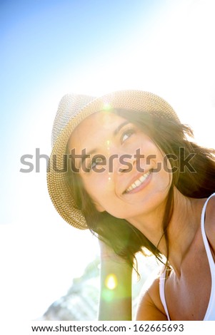 Portrait of beautiful woman with hat, light effect