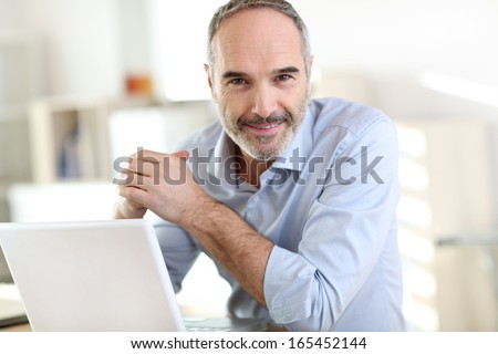 Senior Businessman Working On Laptop Computer