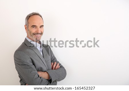 Cheerful Senior Businessman Standing On White Background
