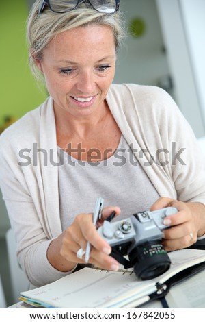 Beautiful mature woman reporter working on project