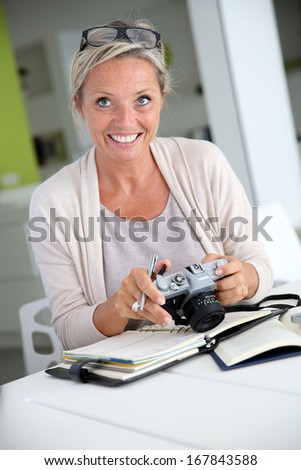 Beautiful mature woman reporter working on project