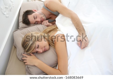 Couple sleeping late in bed