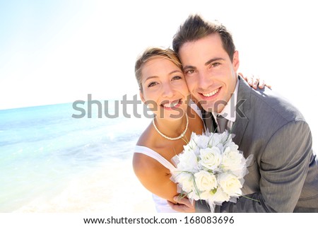 Portrait of just married couple by the beach