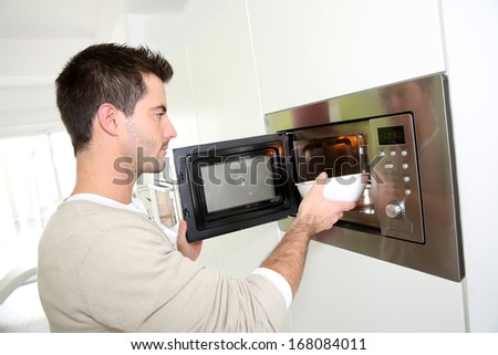 Man heating food in microwave