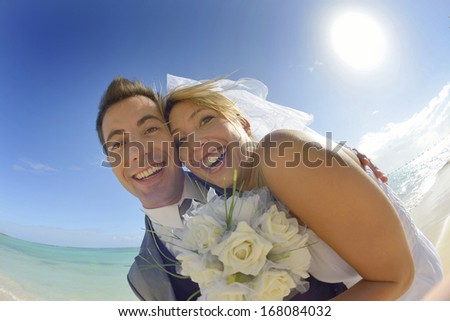 Cheerful couple getting married on the beach