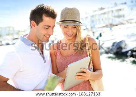 Couple looking at tourist information on tablet
