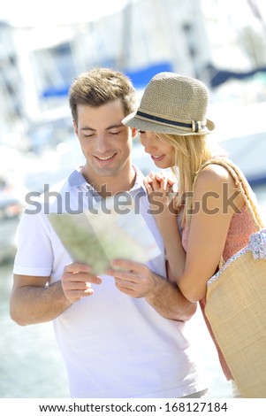 Couple of tourists looking at street map
