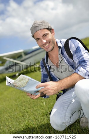 Adventurer looking at tourist map