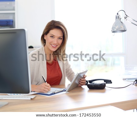 Businesswoman In Office Working With Tablet