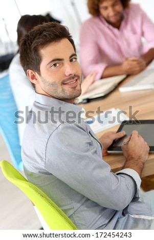 Smiling businessman attending business meeting