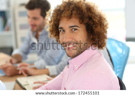 Cheerful man in office attending work meeting