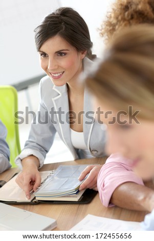 Portrait of smiling business girl attending meeting