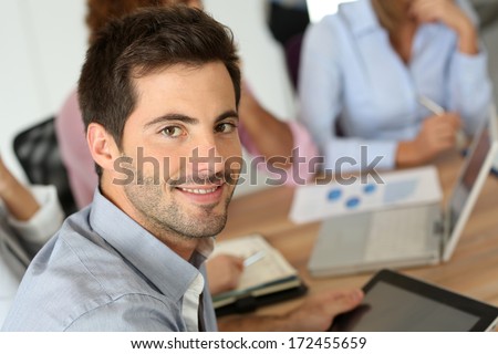 Smiling Businessman Attending Business Meeting