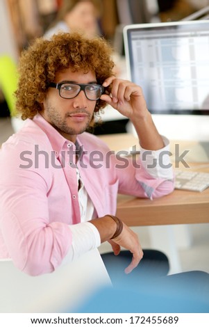 Young man in office working on desktop computer