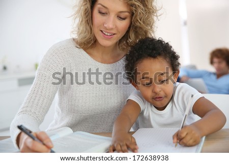 Mom and kid at home making drawing