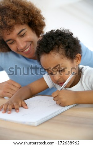 Daddy and son drawing on notebook at home