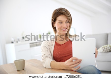 Woman at home connected on internet with tablet