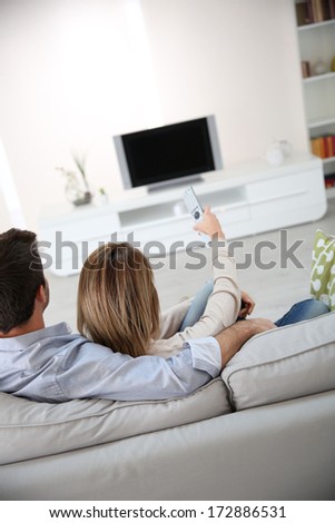 Back view of couple watching tv