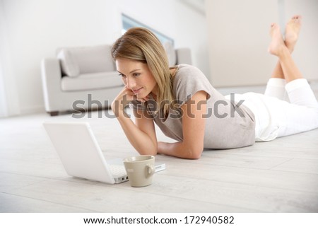 Woman websurfing on the net with laptop