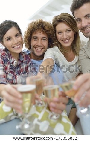 Closeup of friends cheering with glass of wine